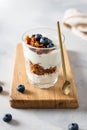 Healthy breakfast with muesli and yogurt. Cereal granola with fruits, berries and nuts in a glass on gray concrete background. Royalty Free Stock Photo