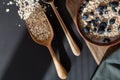 Healthy breakfast. Oat granola with fresh blueberries and currants in a clay bowl over dark grunge surface. Top view, copy space. Royalty Free Stock Photo