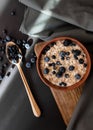 Healthy breakfast. Oat granola with fresh blueberries and currants in a clay bowl over dark grunge surface. Royalty Free Stock Photo