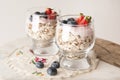 Healthy breakfast, oat meal with fruits: bluebery, strawbery and min, parfait in a glass on a rustic background. Healthy food.