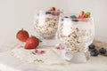 Healthy breakfast, oat meal with fruits: bluebery, strawbery and min, parfait in a glass on a rustic background. Healthy food.