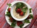 Healthy breakfast oatmeal, bananas and strawberries on wooden background. Royalty Free Stock Photo