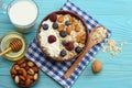 healthy breakfast. oatmeal, blueberries, raspberries, honey, milk and nuts on blue wooden table. Top view with copy space Royalty Free Stock Photo