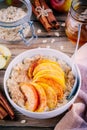 Healthy breakfast: oatmeal bowl with caramelized apples, cinnamon and honey Royalty Free Stock Photo