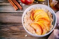 Healthy breakfast: oatmeal bowl with caramelized apples, cinnamon and honey Royalty Free Stock Photo