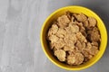 healthy breakfast oatmeal corn flakes in a bowl of yellow with cherry berries on a gray background with space for text copyspace Royalty Free Stock Photo