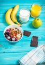 Healthy Breakfast - Oatmeal with fruits, milk and juice at blue table. Royalty Free Stock Photo