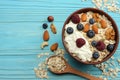 healthy breakfast. oatmeal, honey, blueberries, raspberries and nuts on blue wooden table. Top view with copy space Royalty Free Stock Photo