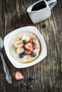 Healthy breakfast with Oatmeal, maple syrup and Berries
