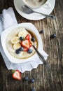 Healthy breakfast with Oatmeal, maple syrup and Berries