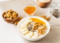 Healthy breakfast - oatmeal with nuts, bananas, chia, mango , side view, close up