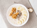 Healthy breakfast - oatmeal with nuts, bananas, chia, top view
