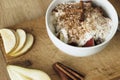 Healthy breakfast with oatmeal, pear, apple, coconut milk and cinnamon