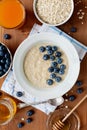 Healthy breakfast of oatmeal porridge, berries, honey and fresh juice Royalty Free Stock Photo