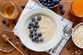 Healthy breakfast of oatmeal porridge, berries, honey and fresh juice Royalty Free Stock Photo