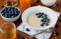 Healthy breakfast of oatmeal porridge, berries, honey and fresh juice Royalty Free Stock Photo