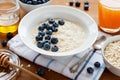 Healthy breakfast of oatmeal porridge, berries, honey and fresh juice Royalty Free Stock Photo