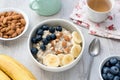 Healthy Breakfast Oatmeal Porridge Bowl with Fruits and Nuts and Cup of Green Tea Royalty Free Stock Photo