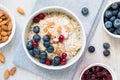 Healthy Breakfast Oatmeal Porridge Bowl with Fruits and Nuts Top View