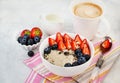 Healthy breakfast with oatmeal porridge, fresh berries and coffee