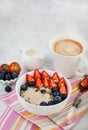 Healthy breakfast with oatmeal porridge, fresh berries and coffee