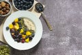 Healthy breakfast with oatmeal porridge, fruits and nuts. Blueberry, mango, pumpkin seeds, nuts, coffee cup. Top view. Clean Royalty Free Stock Photo