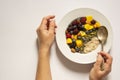 Healthy breakfast with oatmeal porridge, fruits and nuts. Blueberry, mango, pumpkin seeds, nuts, coffee cup. Top view white Royalty Free Stock Photo