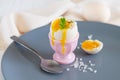 Healthy breakfast with organic boiled egg in eggcup with parsley and pink salt