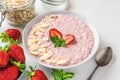 Healthy breakfast. overnight oats with fresh strawberries, almonds and mint in a bowl with a spoon