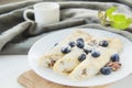 A healthy breakfast of pancakes, berries, butter, and honey