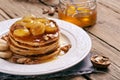 Healthy breakfast of pancakes with honey, nuts and caramelized b Royalty Free Stock Photo