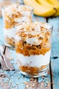 Healthy breakfast parfait. homemade granola with natural yogurt, banana and caramel sauce Royalty Free Stock Photo