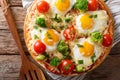 Healthy breakfast pizza with eggs, broccoli, tomatoes and parsley close-up. horizontal top view Royalty Free Stock Photo