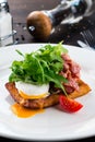 healthy breakfast poached egg with bacon and arugula Royalty Free Stock Photo