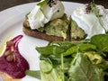 Healthy breakfast poached eggs with avocado and green salad Royalty Free Stock Photo