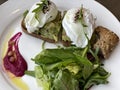 Healthy breakfast poached eggs with avocado and green salad Royalty Free Stock Photo