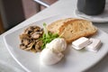 Healthy breakfast with poached eggs, mushrooms and toast bread