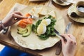 Woman having healthy breakfast with poached eggs and smoked salm Royalty Free Stock Photo