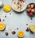 Healthy breakfast with porridge, strawberries, fresh orange juice, mango and nuts place text,frame on wooden rustic background Royalty Free Stock Photo