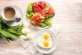 Healthy breakfast prepared with love, fried eggs in heart shape, sandwich with avocado and smoked salmon on lettuce and tomato