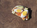 Healthy breakfast. Sandwiches of whole grain bread, scream cream cheese, egg, avocado and salmon fish on a wooden background Royalty Free Stock Photo