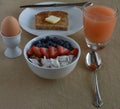 Healthy Breakfast Scene with grapefruite juice, boiled egg, sprouted grain toast, and steel cut oatmeal with fruit