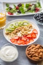 Healthy breakfast served with plate of yogurt muesli kiwi strawberries and banana