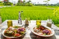 Healthy breakfast served on a vintage table with an emerald green rice field background. Concept of a healthy food and healthy Royalty Free Stock Photo