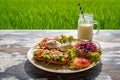 Healthy breakfast served on a vintage table with an emerald green rice field background. Concept of a healthy food and healthy Royalty Free Stock Photo