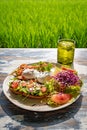 Healthy breakfast served on a vintage table with an emerald green rice field background. Concept of a healthy food and healthy Royalty Free Stock Photo