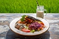 Healthy breakfast served on a vintage table with an emerald green rice field background. Concept of a healthy food and healthy Royalty Free Stock Photo