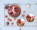 Healthy breakfast set. Bowls of oat granola with yogurt, fresh strawberries, figs, pomegranate andd honey over light