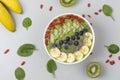 Healthy breakfast smoothie bowl topped with blueberry, kiwi, banana, spinach, Chia seeds and Goji berries. Detox concept. Royalty Free Stock Photo