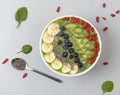Healthy breakfast smoothie bowl topped with blueberry, kiwi, banana, spinach, Chia seeds and Goji berries. Detox concept. Royalty Free Stock Photo